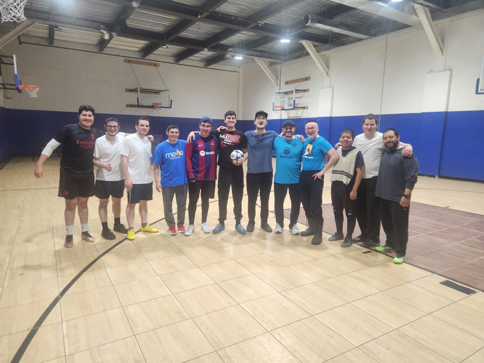 A group of talmidim together in the gym after playing