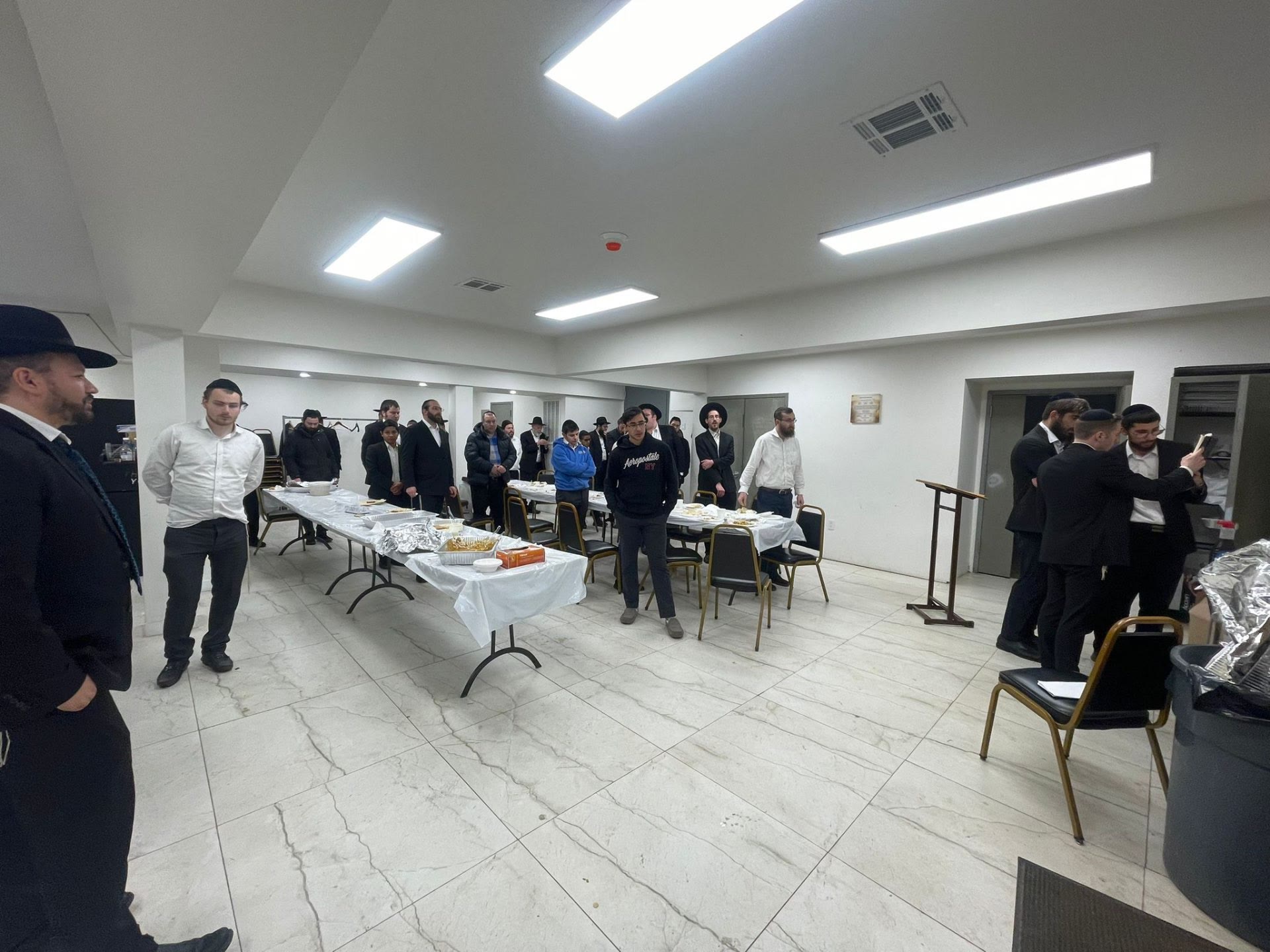 Talmidim standing quietly at their places before a meal