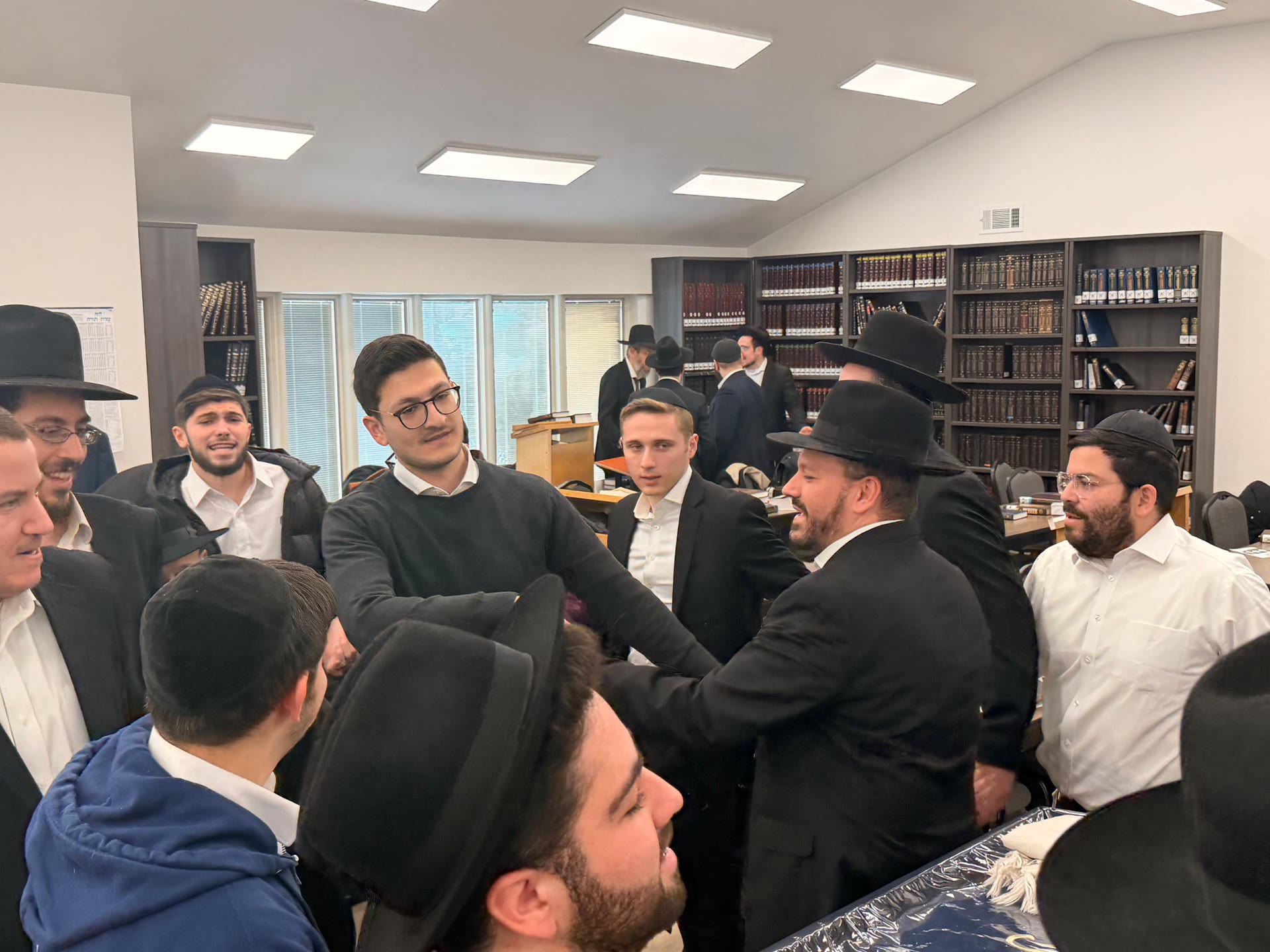 A talmid smiling while learning with his chavrusa