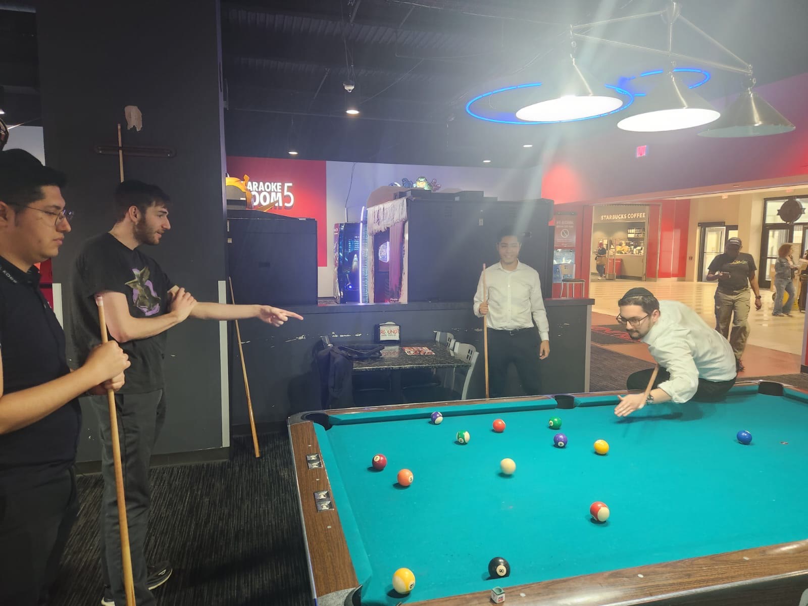 Talmidim playing pool together during an outing