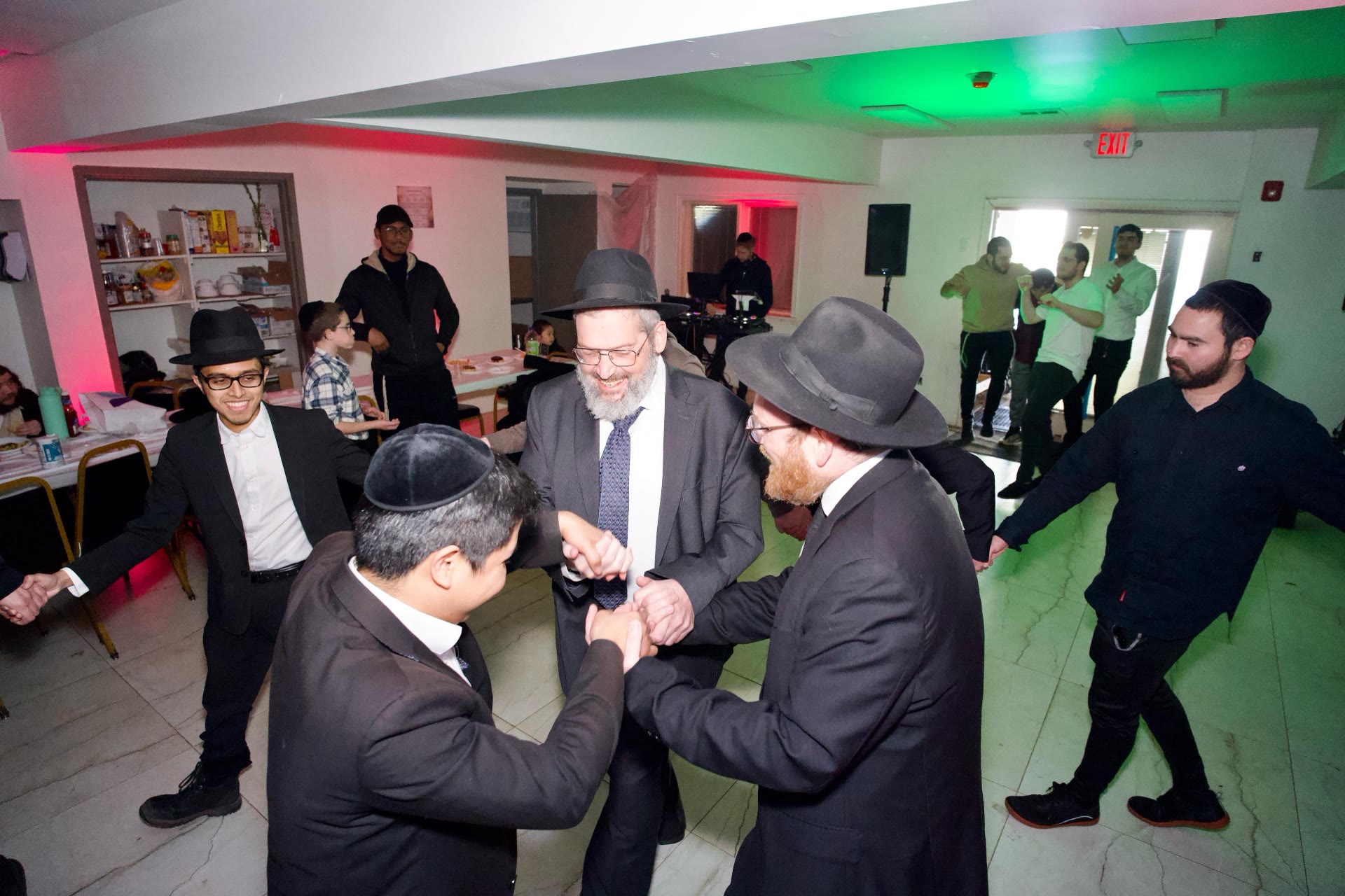 Men dancing in a circle at a simcha