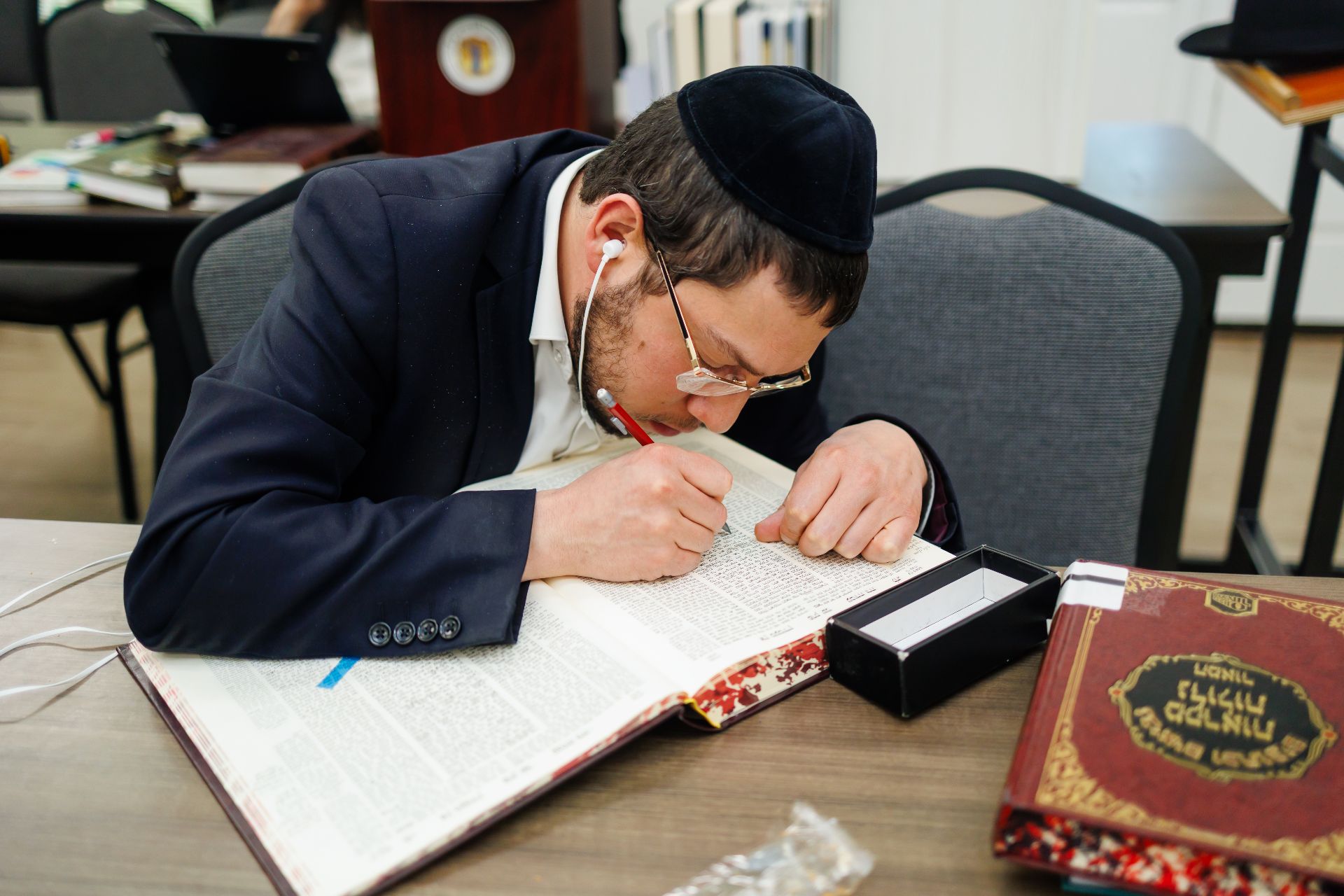 A kollel member learning at his shtender in the Beis Medrash